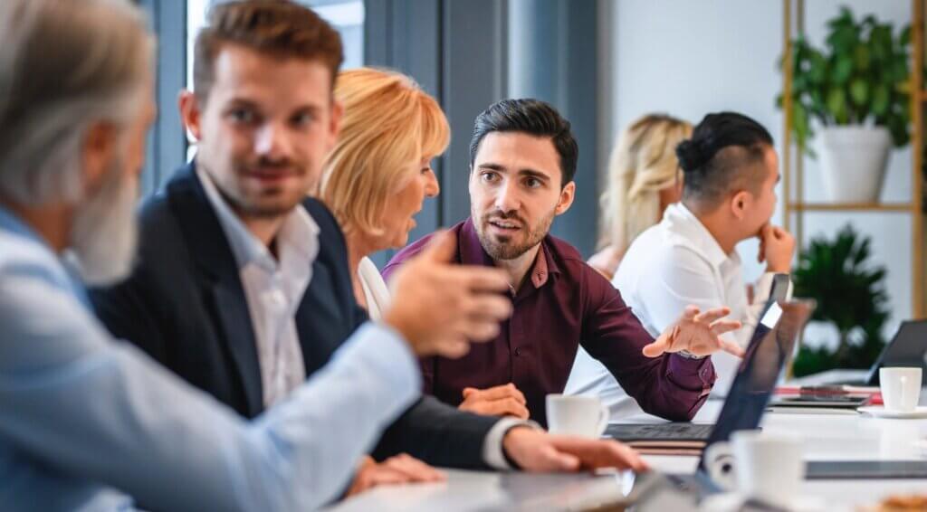 Woman expressing herself in a meeting with male colleagues